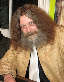 Hopefully, with better hair though. Alan Moore from the wiki linked above.